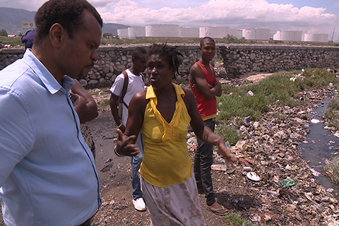 This is a photo of Dr. Marcelin in Haiti. He is speaking with a group of local community members.